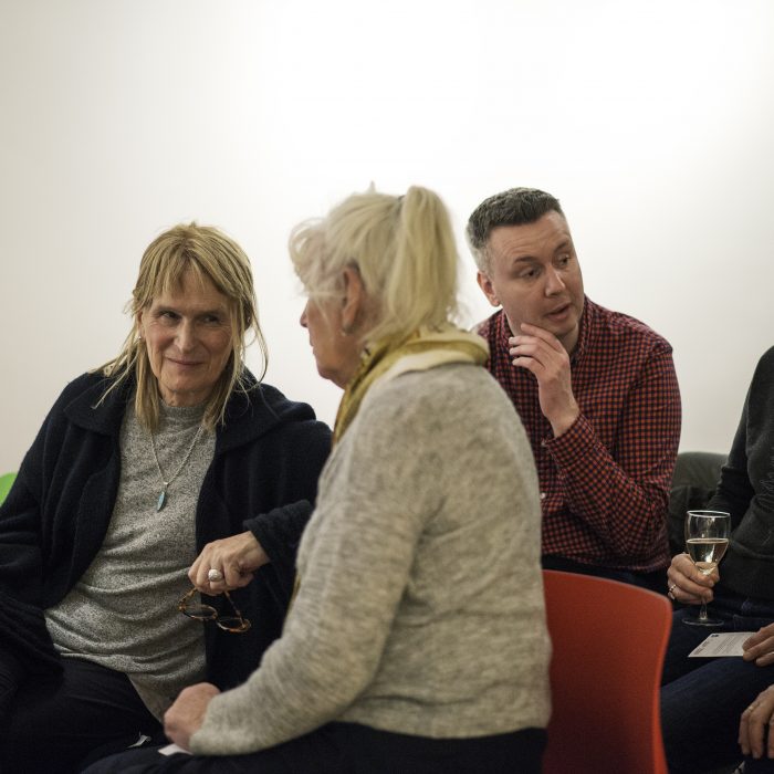 Group of people sat talking to each other at our project launch.